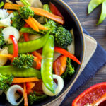 Healthy stir fried vegetables in the pan and ingredients close up